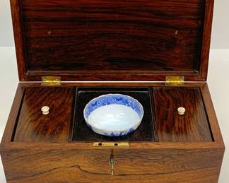 Lot # 45	$200.00	ANTIQUE TEA CADDY WITH THREE COMPARTMENTS, BONE PULLS AND KEY	Height 6.5 in, width 12 in, depth 6 in. Mahogany tea caddy on bun feet has two tea compartments with bone pulls and original key. Japanese blue and white tea cup is included in the center compartment.	Bid at Woodardlipe.com or call 314-899-0098 for more information.