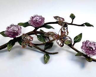 Lot # 104	$1,500.00	JAY STRONGWATER VENETIAN GLASS FLOWERS AND BUTTERFLIES ON BEJEWELED BRANCH, 2008.	Height 7 in., length  28 in., width 12 in., Enamel finish and glazed elements. with profuse glazed leaf forms and three large pink Swarovski crystal floral forms, and three large enameled and gilded openwork metal butterflies, with a profusion of hand-set Swarovski crystals.	Bid at Woodardlipe.com or call 314-899-0098 for more information.