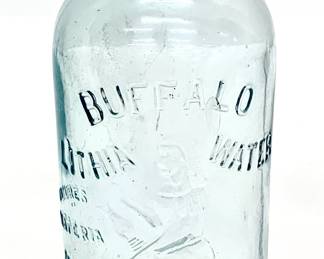 Lot # 6  	$25.00	BUFFALO LITHIA SPRINGS 19OO MINERAL WATER GLASS BOTTLE	"Height 10 in., diameter 4.5 in. Antique Buffalo Lithia Water Bottle
in light aqua glass with raised lettering. Buffalo Lithia Water (later Buffalo Mineral Springs Water) was a brand of lithia water bottled in Buffalo Lithia Springs, Virginia. It was advertised as able to treat fevers and nervous disorders and was sold from the late 19th century to the early 20th. At the height of its popularity, it was available in approximately groceries and pharmacies in Europe, Canada, and the United States."	Bid at Woodardlipe.com or call 314-899-0098 for more information.