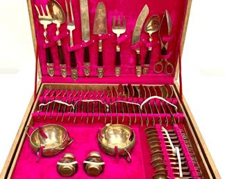 Lot # 60	$300.00	SIAM STAMPED BRASS WITH ROSEWOOD HANDLE 149 PIECE SERVING SET FOR 12	Mid Century Modern Siam Complete 149 piece service for 12 including cream and sugar, salt and pepper, 13 separate serving utensils and 12 complete serving sets (11 items total per set).  Set is displayed in a 3 layer case with sliding drawers. Pink velvet interior. Originally sold through James, dealers of gems and jewelry, silver-niellowares, and bronze wares, Bangkok, Thailand.	Bid at Woodardlipe.com or call 314-899-0098 for more information.