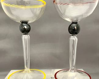 Lot # 29	$100.00	PAIR VENETIAN HAND BLOWN CHAMPAGNE GOBLETS WITH LIP AND BASE COLORED WRAPS	Height 7 in., diameter 4 in.  Classic hand blown Murano twist top and hollow stem goblets both featuring a fine colored lip and foot wrap, significant solid black glass marble and very accomplished pontil marks on bottom. Unsigned.	Bid at Woodardlipe.com or call 314-899-0098 for more information.