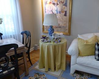 Skirted table, bric-a-brac, antique framed French poster