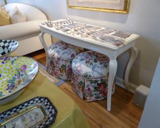 French Country console table, pair of round floral ottomans, sterling silver flatware set