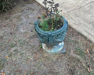 concrete yard planter with greek key design painted green