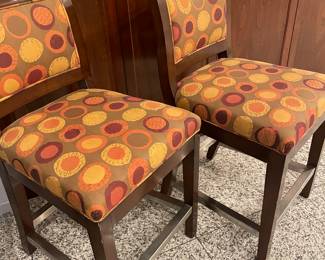 Counter-height stools with wood backs and upholstered seating, with stainless foot rests (4 sides). Upholstry is in good condition, wood trim has light wear - set of 4 available