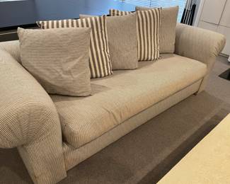 Pair of sofas - upholstered by Menage - turned arms and loose back cushions - water damage on base of legs - and wear on cushions (AS - IS)