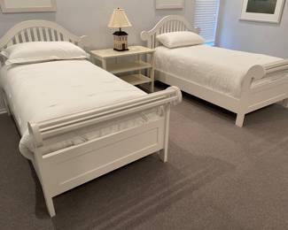 Pair Twin white painted beds - sleigh beds style - with mattress sets and linens (duvets, sheets, king pillows) - height of headboard 46" , shown with 3-tier nightstand/bookcase and lamp
