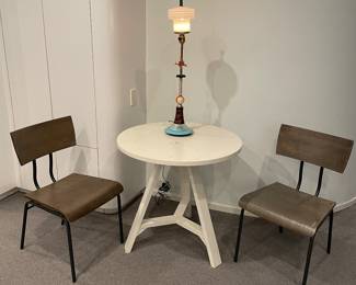 Painted round side table 30" x 29" - some visible wear and a pair of Crate & Barrel wood side chairs with metal legs and back support - good condition - shown with art deco light