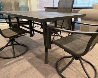 Another view of the Patio dining table - gray metal - with 4 chairs - gray metal base (rocker) and tan mesh - very good condition