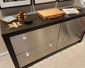 4-drawer file cabinet/dresser with stainless front and pulls shown with wood games, leather coasters