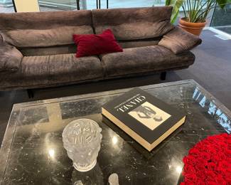 Another view of the Italian custom upholstered seating: couch by B. B. Alanda (back upper portions adjusts to resting position) with colored mohair pillow, black marble cocktail table (66" square x 17"), Chanel book, and Venus et Fluer - silk rosebuds (Lalique vase NFS)