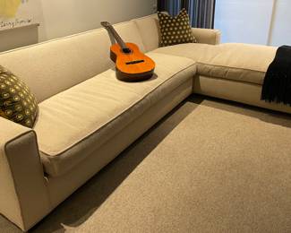 L-shaped sofa (back height 33") by R. Jones - very good condition with 2 velvet backed MCM style pillows; shown with Fender acoustic guitar