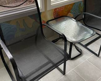 Another view of the black metal armchair and side table