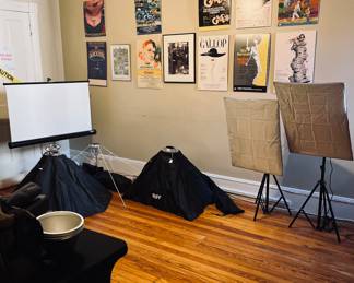 Studio lighting and framed theater posts (some signed by performers) 