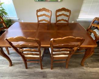 Wooden dining room set with 6 chairs (incl. 2 arm chairs).  Extension leaf.  In good condition but some seat cushions need fixing.