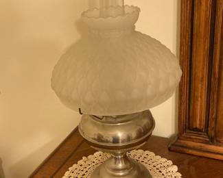 This oil lamp has a beautiful frosted shade.