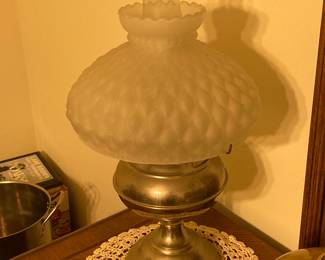 The oil lamp with the beautiful frosted top is for sale.