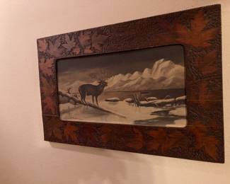 A very old piece of wall art in a gorgeous frame.