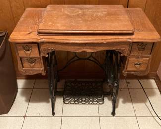Here is a vintage sewing machine cabinet. I think the sewing machine is inside, but we can’t get the lid to come up.