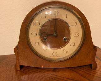 There is an antique clock with key.