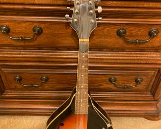 There are two guitars and a mandolin for sale.