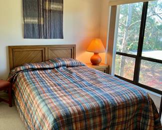 Full size bed with headboard and nightstand