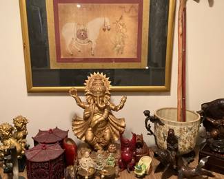 Framed & matted picture under glass on wall above the collectibles on chest in entry