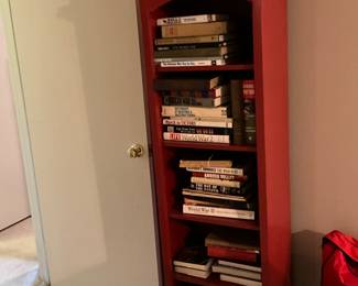 Red bookcase with more books