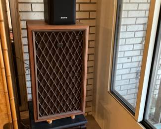 Speakers on stool in sunroom
