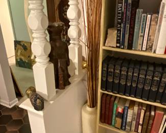 Urn with decor next to built in bookcase