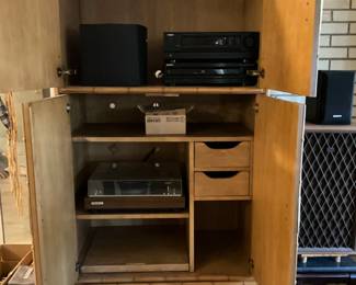 Electronics cabinet open with items 