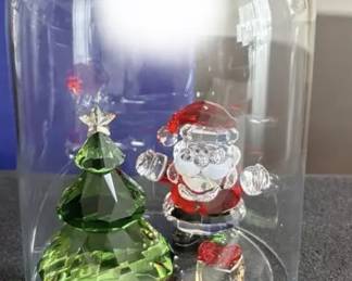 At least 25 Swarovski Santa s
