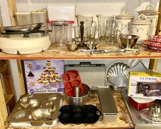 Kitchen bakeware, glass pitchers/glasses, canisters (2 are as is), tupperware, etc. (some SOLD)