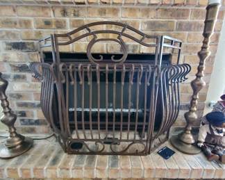 Iron 3-fold Fireplace fence and behind it an electric infrared fireplace,
