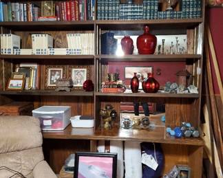 Vintage blue encyclopedia set, brass candle sticks, assorted ginger jars and ceramic Chinese pots, Hand weights. Glass and mirror pieces.  Decorative glass balls/globes. Variety of books, crosses, stones and art.