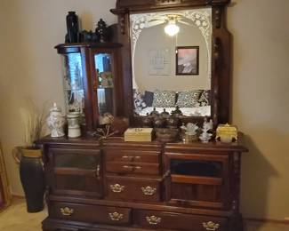 Dresser with mirror and lighted curio cabinet, part of 5-piece king waterbed bedroom suite.  Assorted decorative glass and ceramic decorations and jewelry boxes. 1970s Ginger Jars.