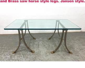 Lot 66 Regency style glass top table. Steel and Brass saw horse style legs. Jansen style.