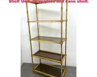 Lot 237 Regency Style Gilt Metal Etagere Shelf Unit. Gray glass and cane shelf.