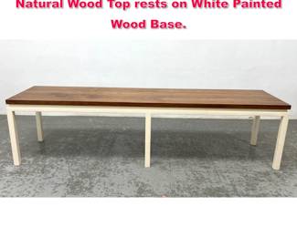 Lot 222 Modernist Wood Coffee Table Bench. Natural Wood Top rests on White Painted Wood Base.