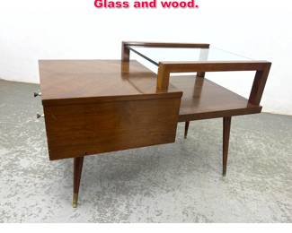 Lot 581 James Phillip Co step end table. Glass and wood.