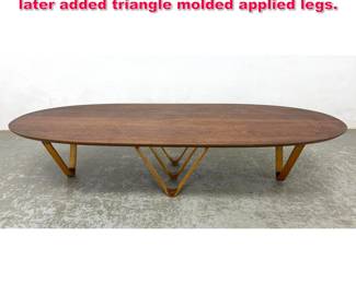 Lot 357 Walnut Surfboard coffee table with later added triangle molded applied legs.