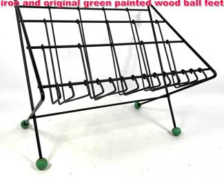 Lot 221 Tony Paul magazine rack. Wrought iron and original green painted wood ball feet