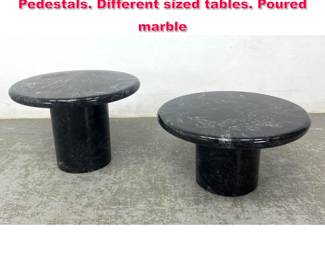 Lot 132 2pc Black Marble Round side tables. Pedestals. Different sized tables. Poured marble