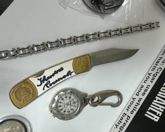 NRA limited edition, Theodore Roosevelt, lockback knife, Remington keychain chroma glow pocket watch 1967 silver Kennedy half dollar. And more in this combined lot