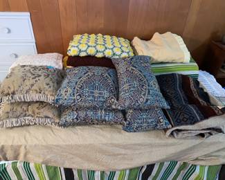Assorted decorative pillows and bedding