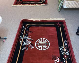 2 Asian inspired black and red rugs