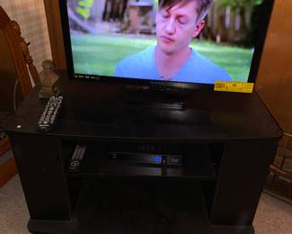 Magnavox TV and black tv stand