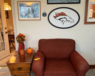 Rust colored club chair with ottoman,
Vintage maple dough box end table,
Artwork