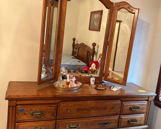 Matching oak dresser with mirror. 
There is a matching bed as well. 