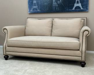 BLOOMINGDALE’S TAN SOFA LOVESEAT | Clean tan fabric upholstery, deep seats with a fancy brass tack border. - h. 34 x w. 71 x d. 44 in